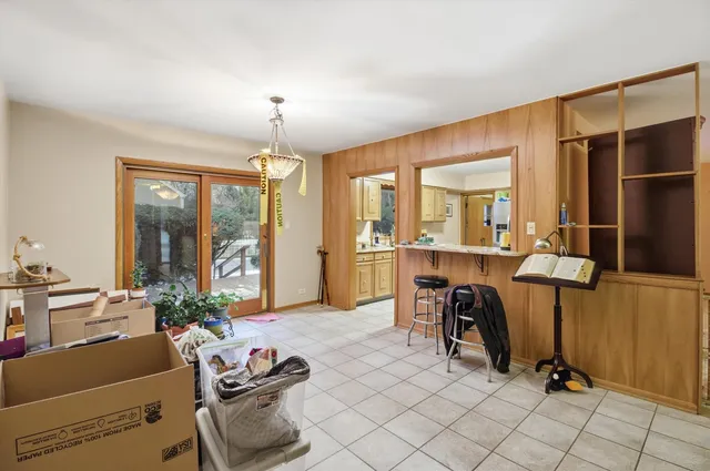 a view of a workspace with furniture and a chandelier