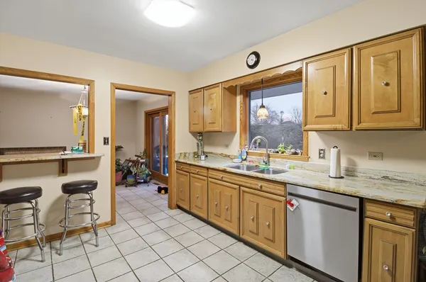 a bedroom with a bed couches and window