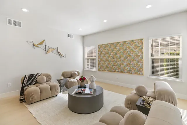 a kitchen with a dining table chairs and white cabinets