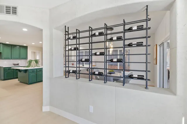 a view of a dining room and livingroom with furniture a rug and a kitchen