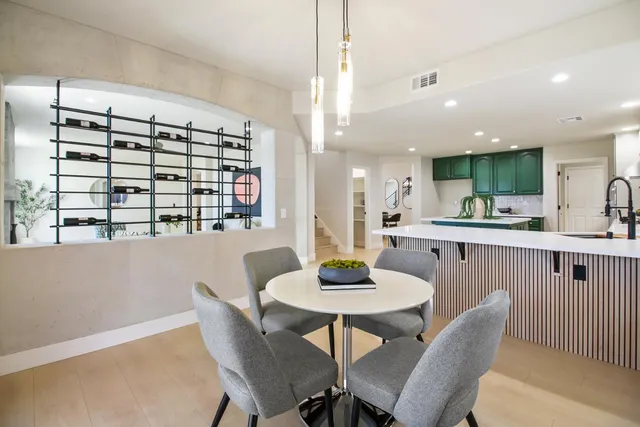 a kitchen with kitchen island a sink and a stove