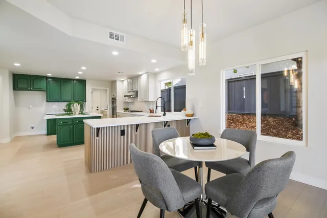 a view of a dining room with furniture a chandelier and wooden floor