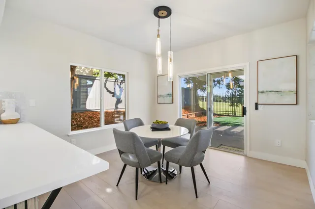 a living room with furniture a rug and a chandelier