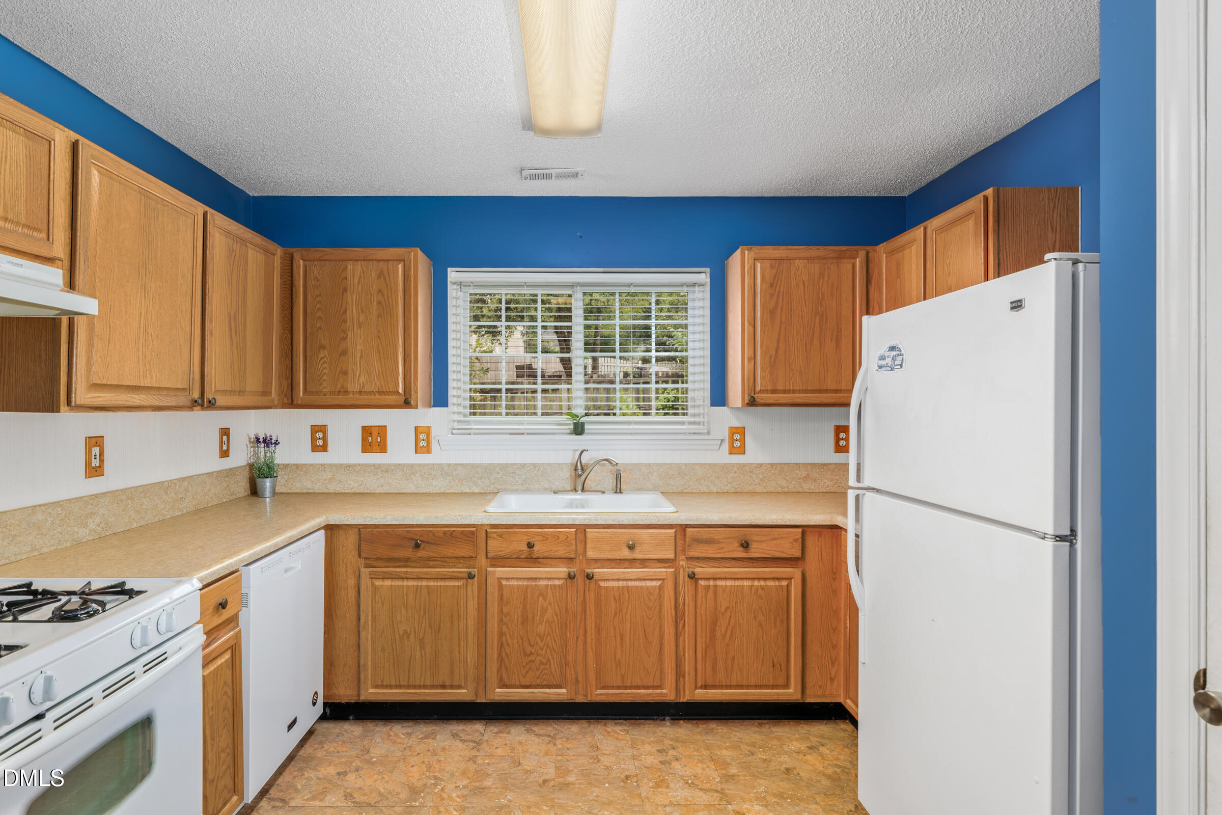 6 Tinsbury Place Durham, NC 27713 - Photo 11 of 30 a kitchen with a sink a refrigerator and window