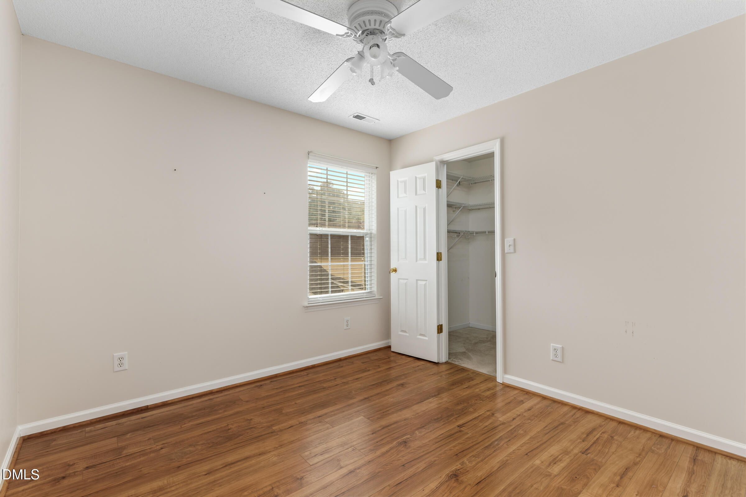 6 Tinsbury Place Durham, NC 27713 - Photo 16 of 30 an empty room with a chandelier fan and windows