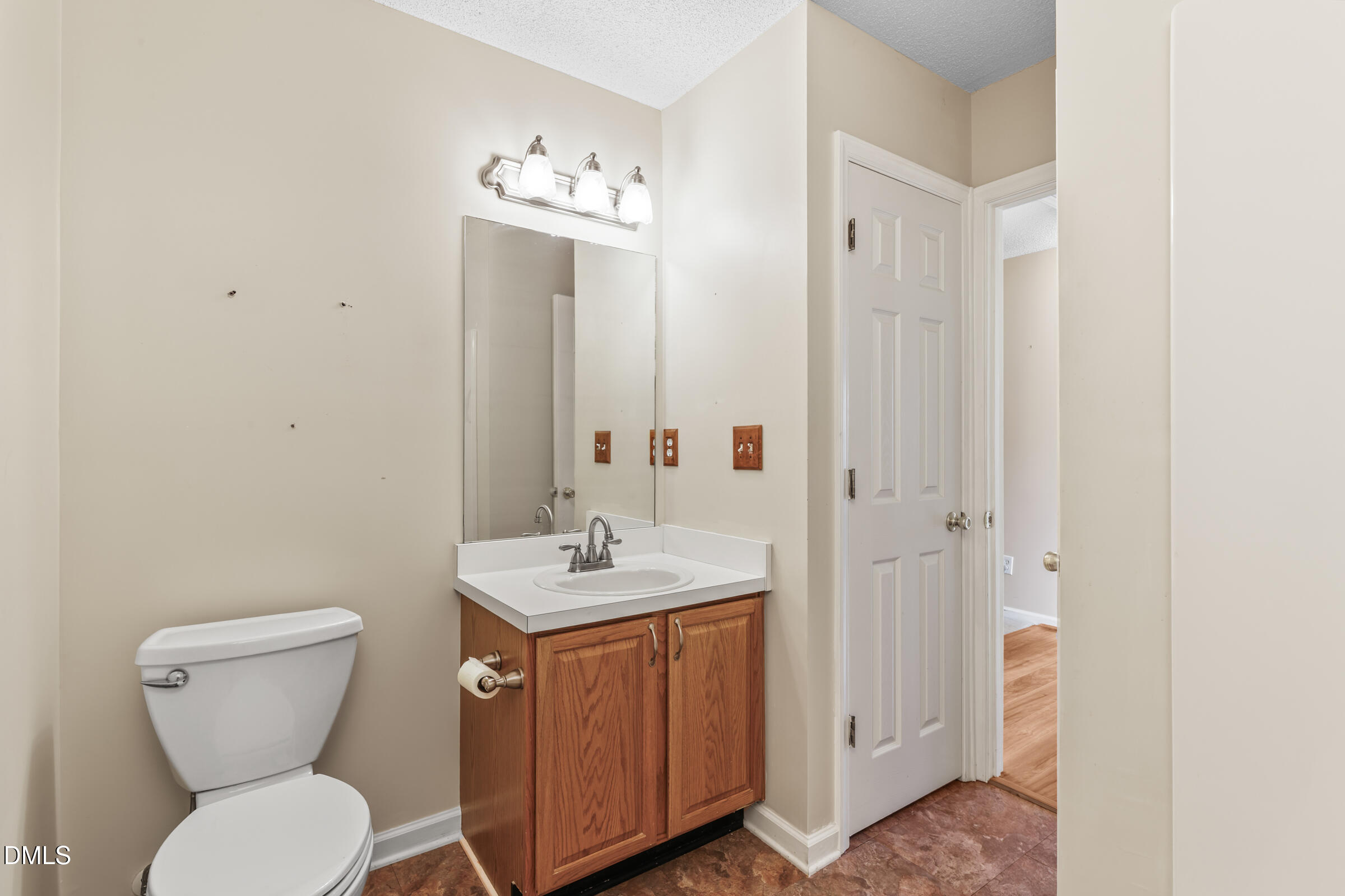 6 Tinsbury Place Durham, NC 27713 - Photo 19 of 30 a bathroom with a toilet a sink and mirror