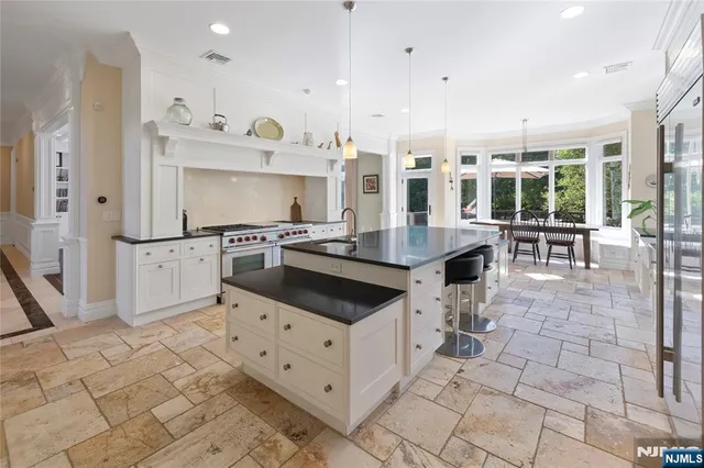 a kitchen with a stove a sink and a refrigerator