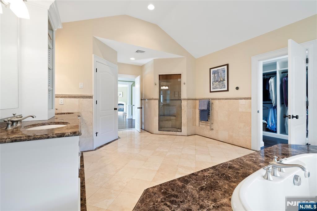417 Rte 9W Alpine, NJ 07620 - Photo 20 of 50 a spacious bathroom with a granite countertop sink and a mirror