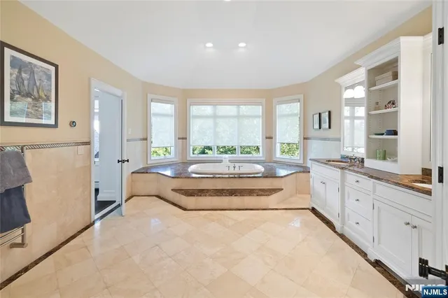 a spacious bedroom with a large bed and a large window