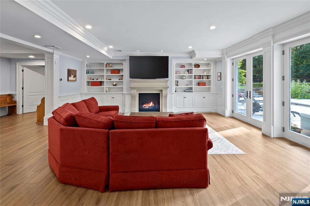 417 Rte 9W Alpine, NJ 07620 - Photo 30 of 50 a living room with furniture a flat screen tv and a fireplace