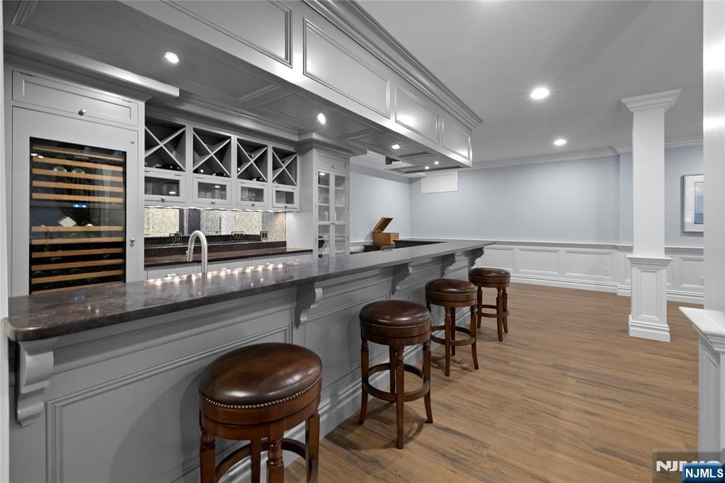 417 Rte 9W Alpine, NJ 07620 - Photo 34 of 50 a kitchen with stainless steel appliances granite countertop a table chairs cabinets and wooden floor