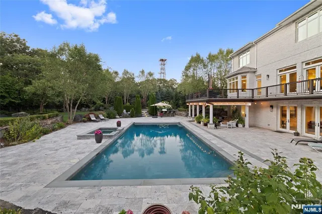 swimming pool view with a garden space