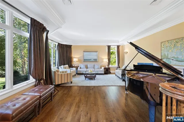 a living room with furniture stove and large window