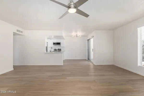 an empty room with a empty space and windows