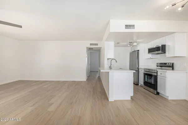 a view of kitchen with sink and wooden floor