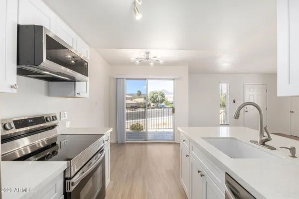 a kitchen with stainless steel appliances a sink and a stove top oven