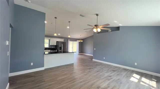 a view of a kitchen with a sink and a window
