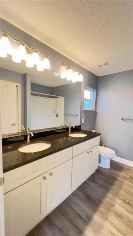 a large bathroom with a granite countertop sink and a mirror