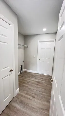 an empty room with wooden floor and closet