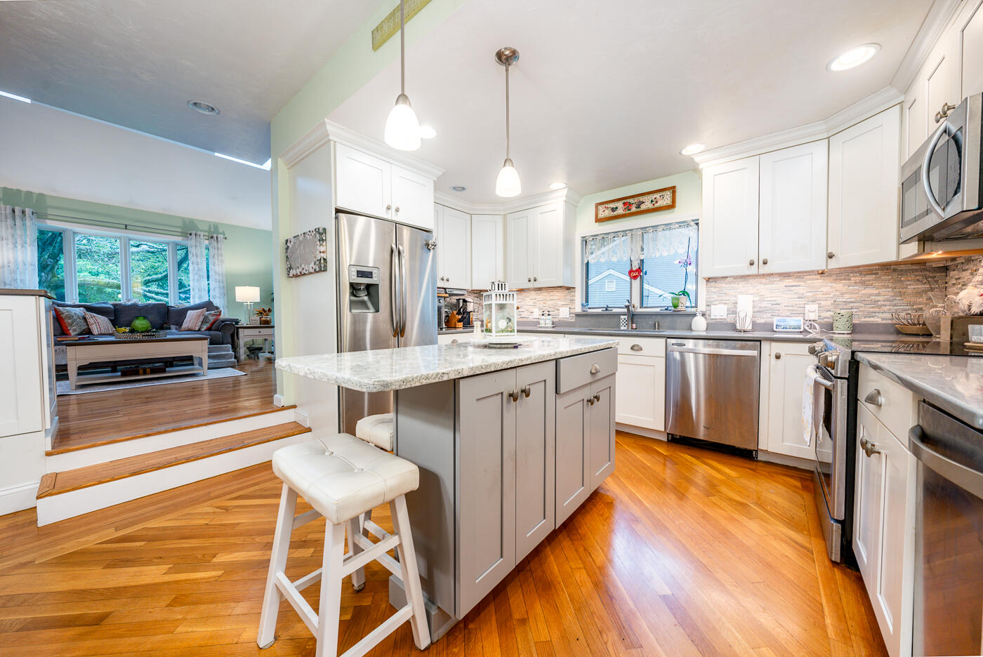 23 Redwood Circle Mashpee, MA 02649 - Photo 11 of 40 a kitchen with cabinets and chairs