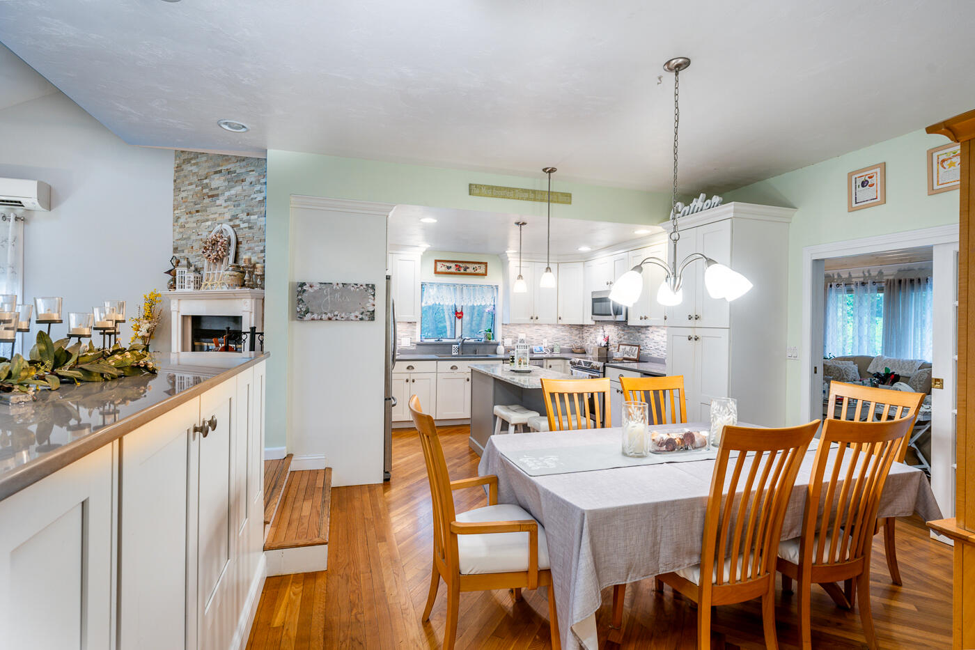 23 Redwood Circle Mashpee, MA 02649 - Photo 16 of 40 a kitchen with stainless steel appliances kitchen island granite countertop a table chairs and a refrigerator