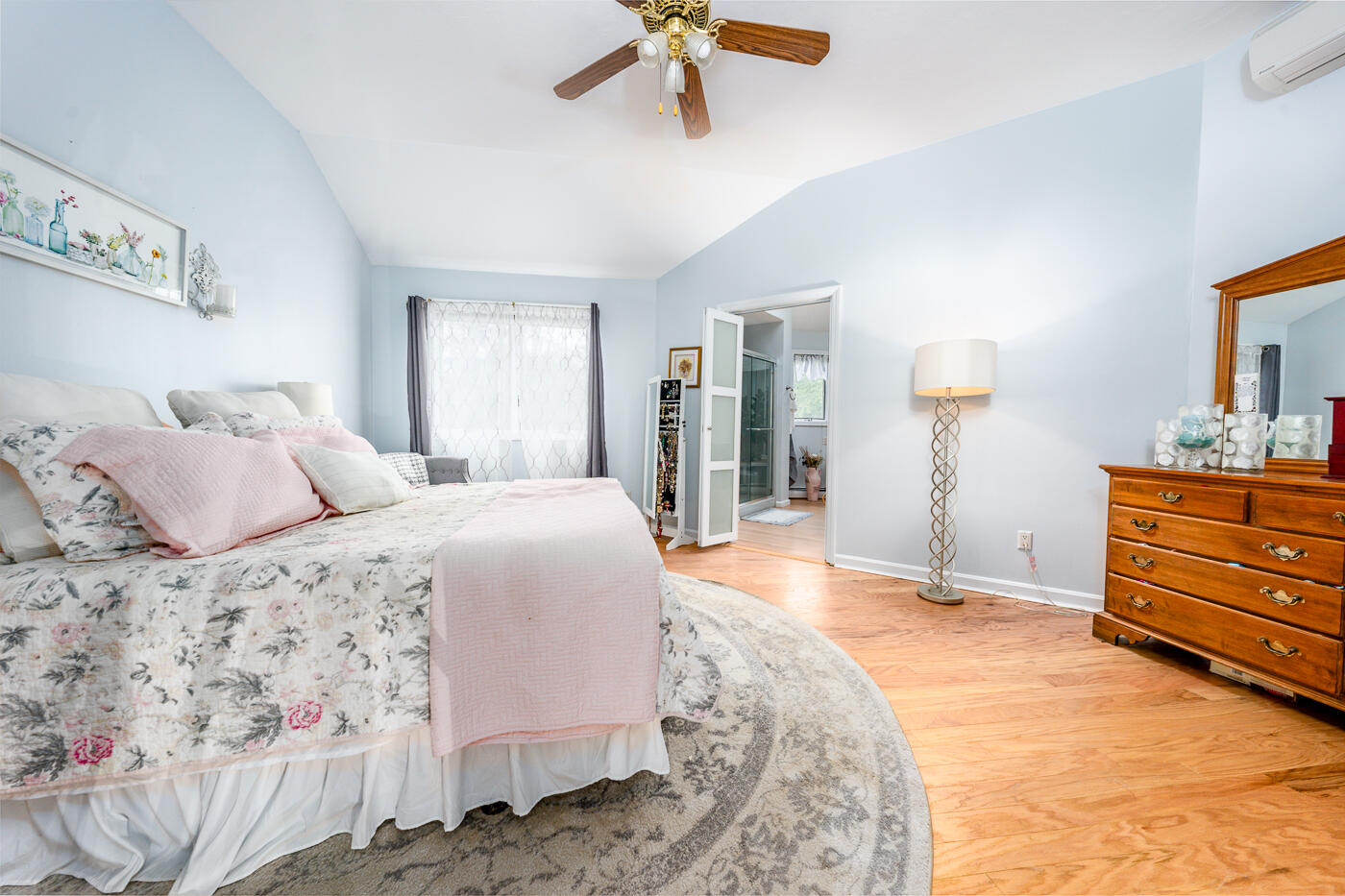 23 Redwood Circle Mashpee, MA 02649 - Photo 22 of 40 a bedroom with a bed and a chandelier