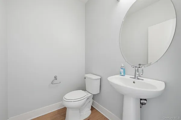 a bathroom with a sink a toilet and mirror