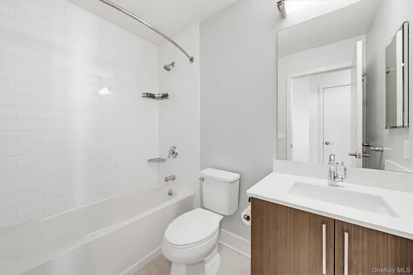 a bathroom with a sink toilet vanity and shower
