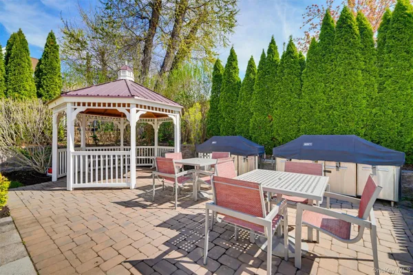 a view of a chairs and table under an umbrella