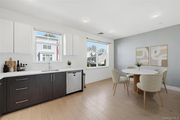 a kitchen with a table chairs sink and cabinets