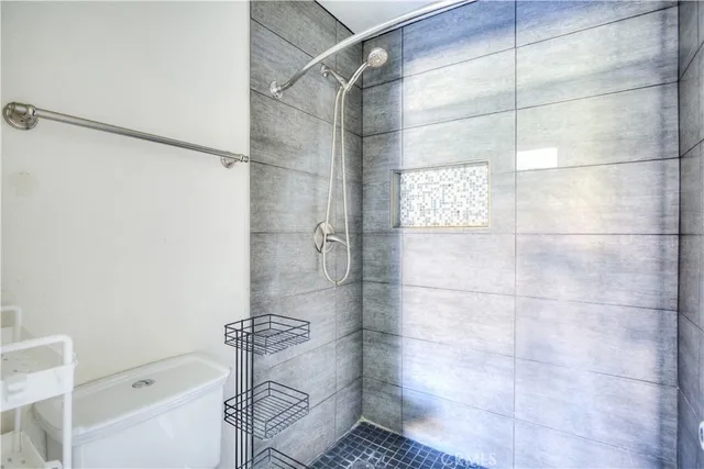 a bathroom with a shower and toilet