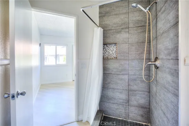 a bathroom with a glass door shower