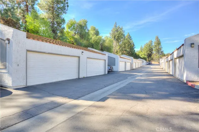 a view of a patio with table and chairs with wooden fence