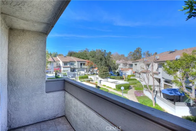 a view of a white house with a yard and table and chairs