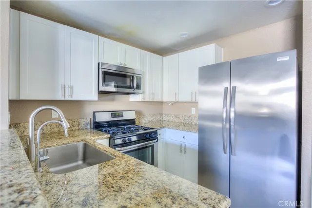 a kitchen with a refrigerator stove and microwave