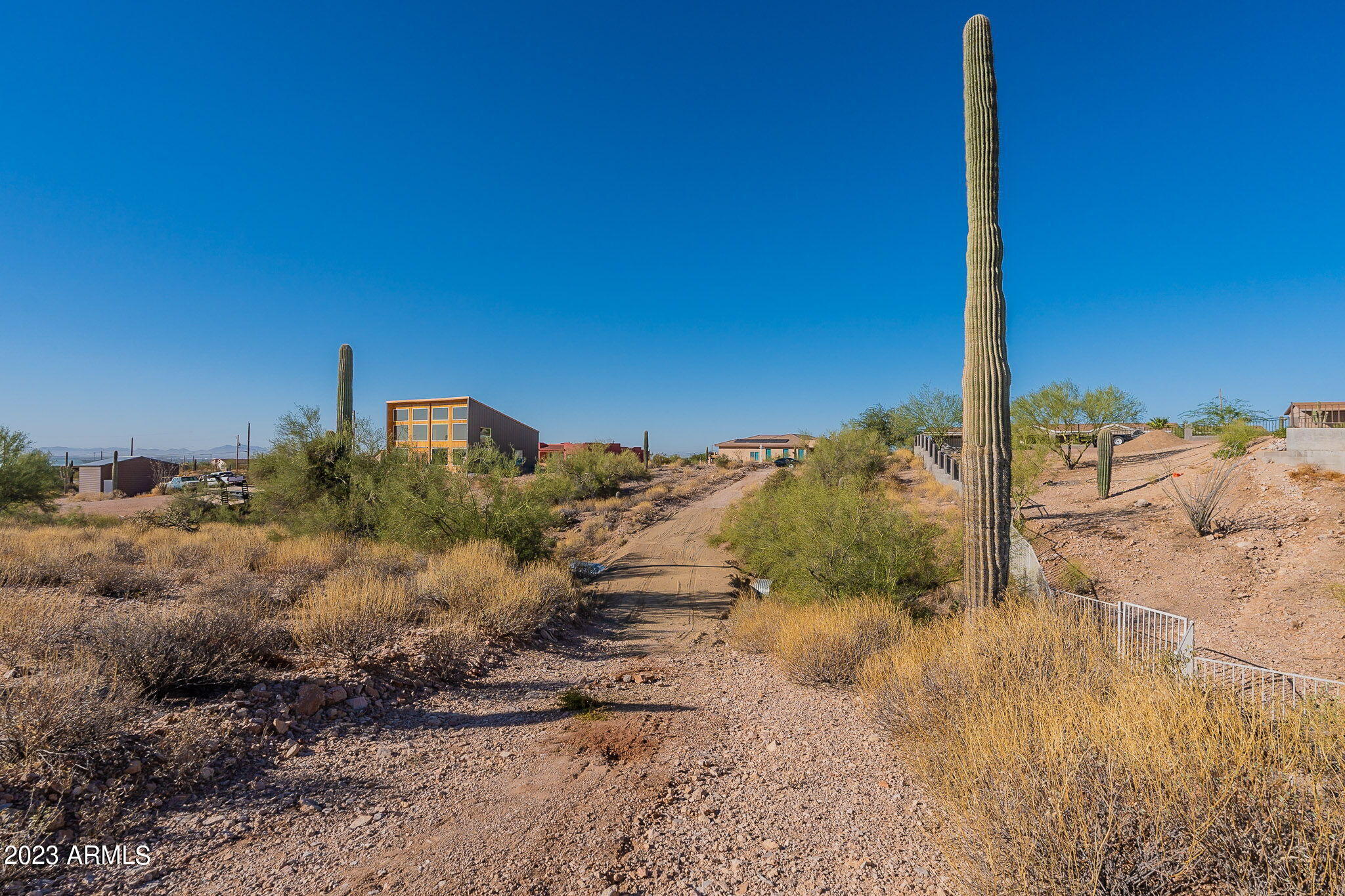 0 North Idaho Road Apache Junction, AZ 85119 - Photo 21 of 24 a view of a dry yard with wooden fence
