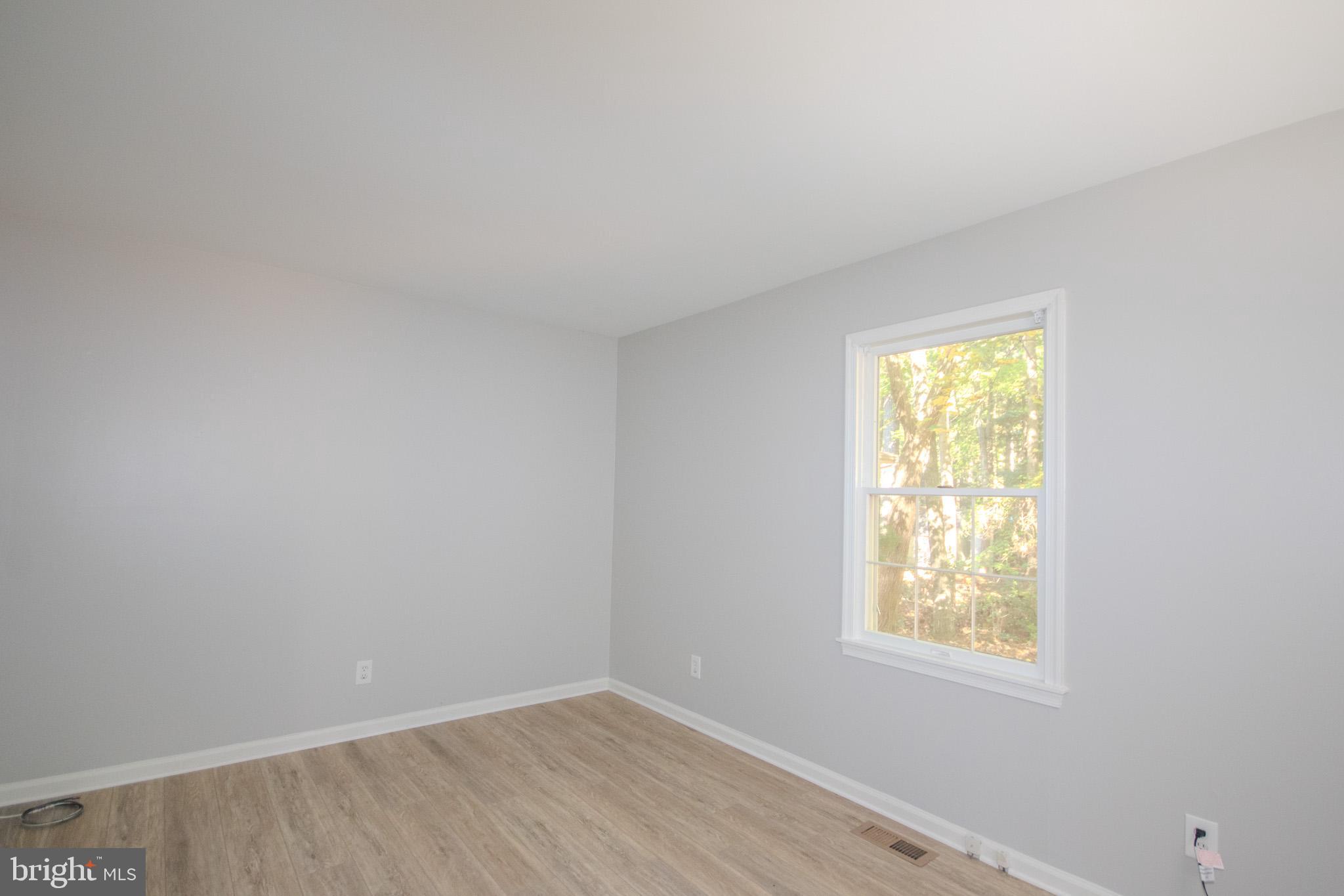 103 Ocean Parkway Ocean Pines, MD 21811 - Photo 11 of 44 an empty room with windows