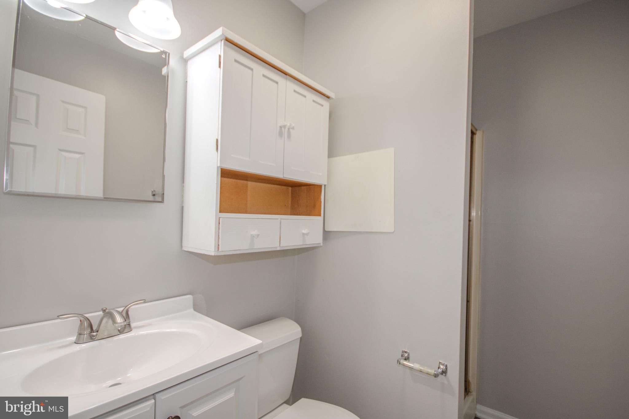 103 Ocean Parkway Ocean Pines, MD 21811 - Photo 23 of 44 a bathroom with a sink mirror and toilet