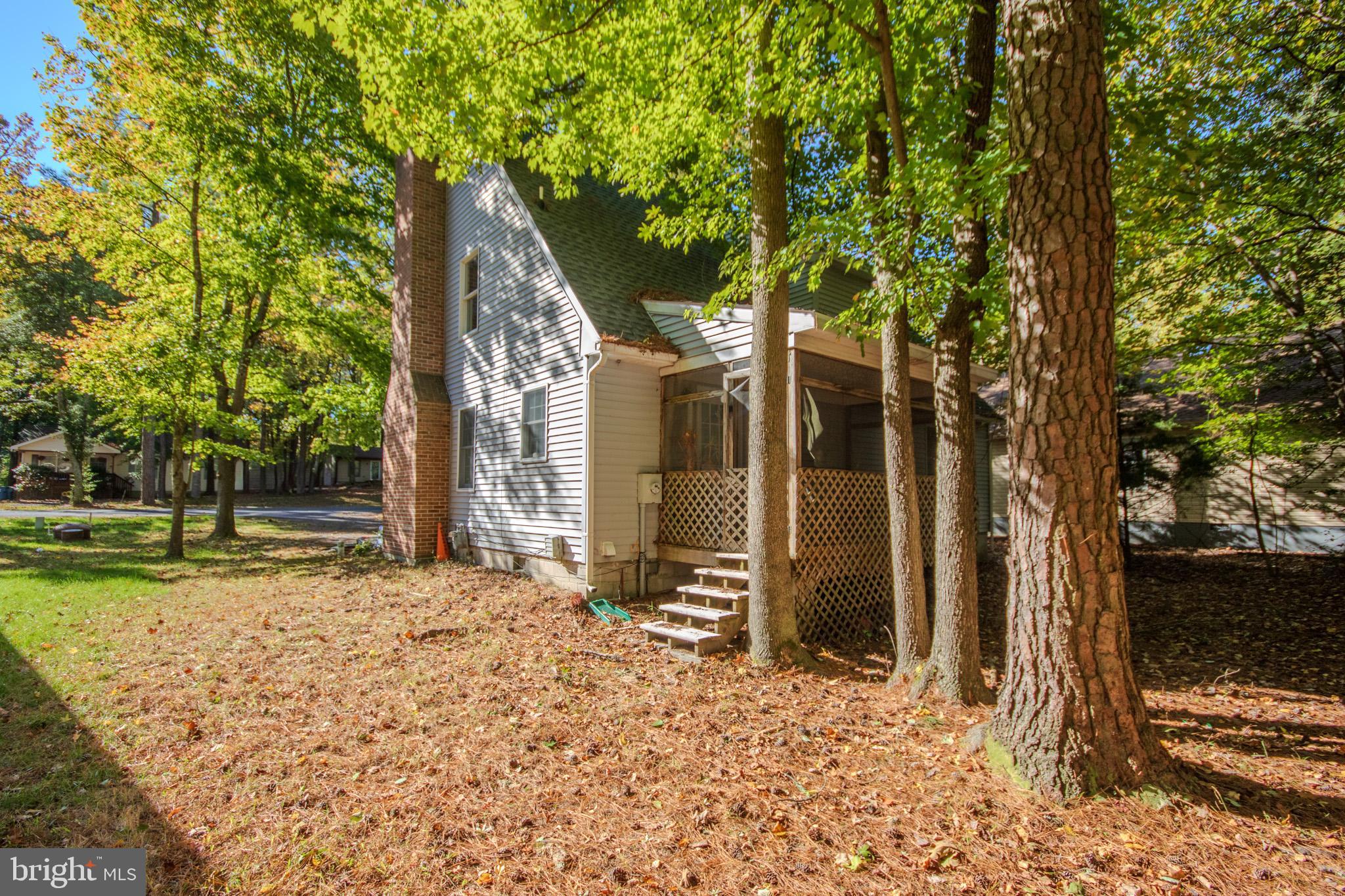 103 Ocean Parkway Ocean Pines, MD 21811 - Photo 29 of 44 a backyard of a house with lots of green space