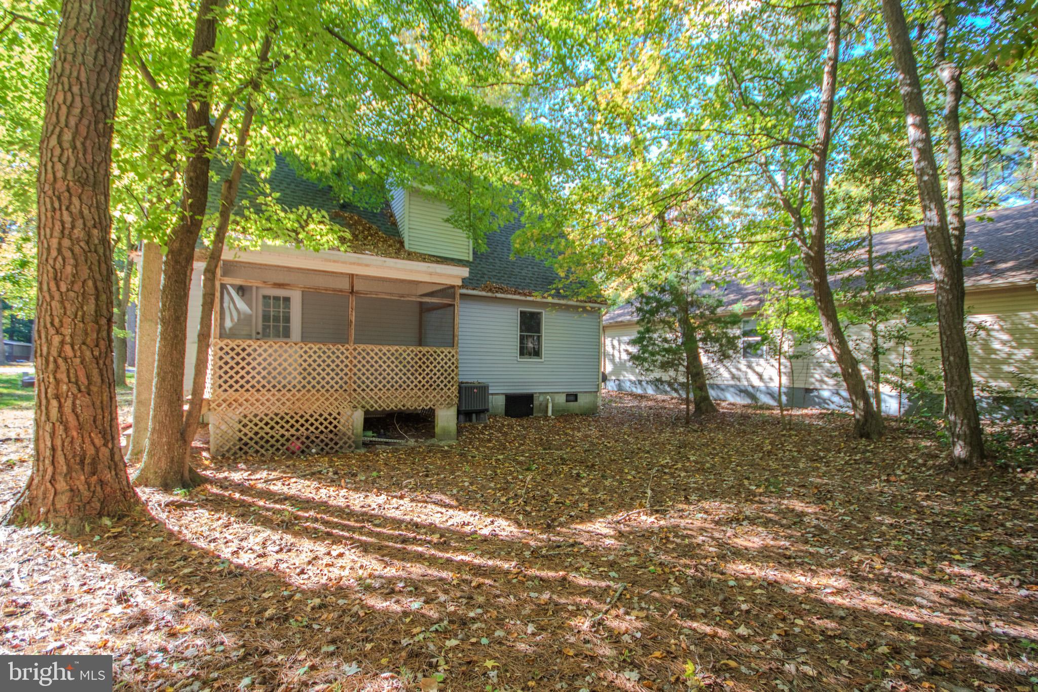 103 Ocean Parkway Ocean Pines, MD 21811 - Photo 33 of 44 a view of a house with a yard tree and wooden fence