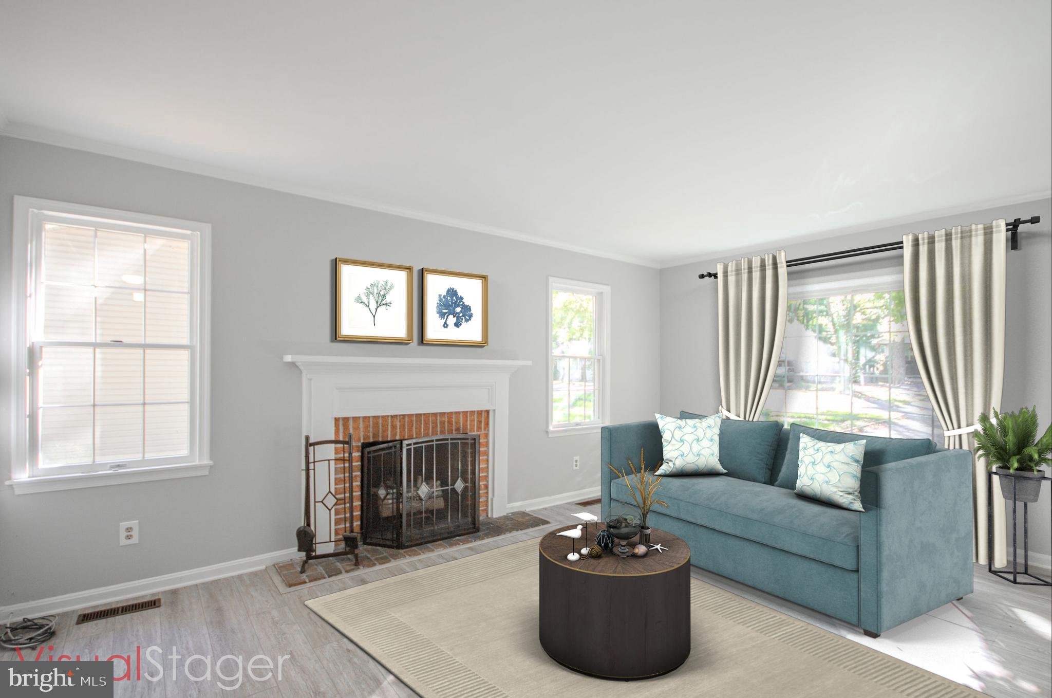 103 Ocean Parkway Ocean Pines, MD 21811 - Photo 5 of 44 a living room with furniture and a fireplace