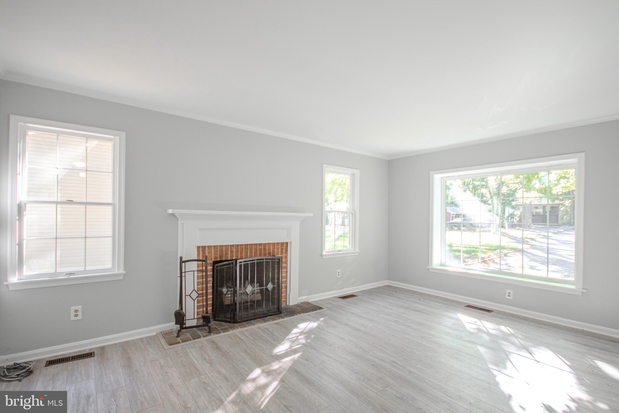 103 Ocean Parkway Ocean Pines, MD 21811 - Photo 6 of 44 an empty room with windows and fireplace