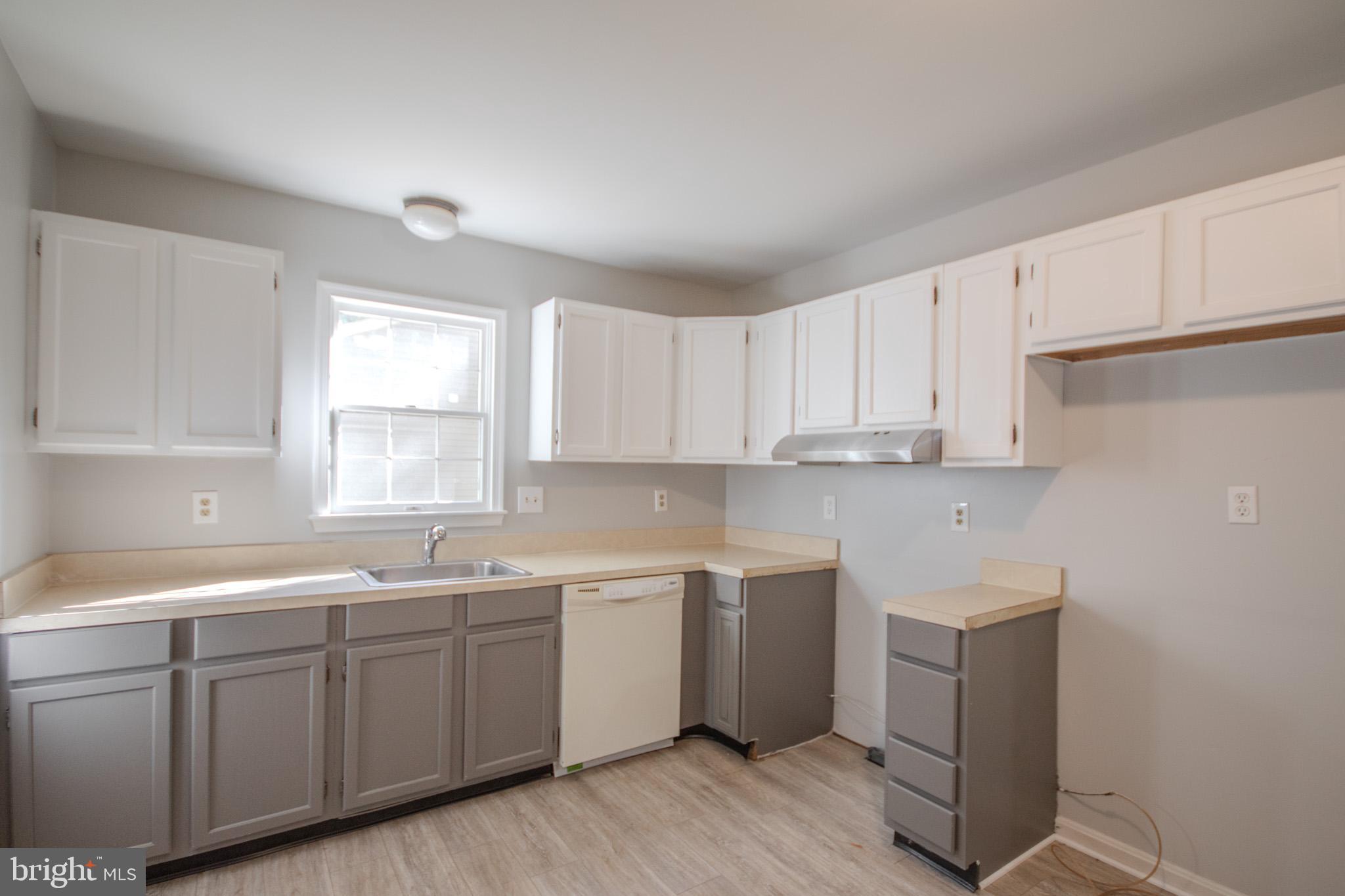 103 Ocean Parkway Ocean Pines, MD 21811 - Photo 10 of 44 a kitchen with sink cabinets and window