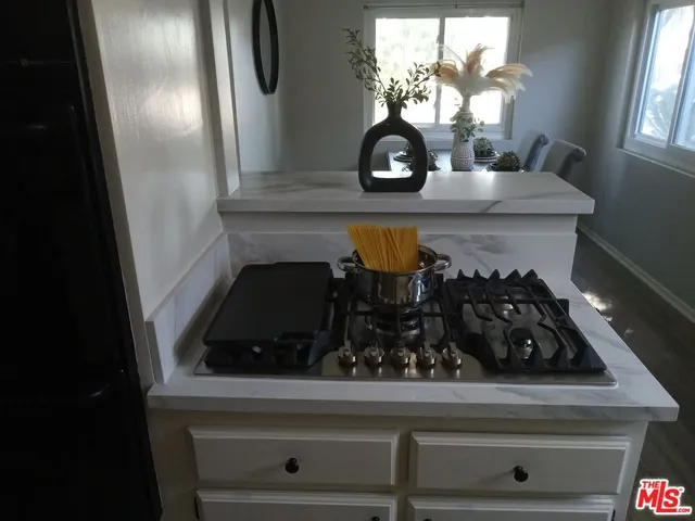 a kitchen with a stove and cabinets