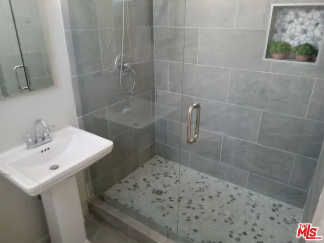 a bathroom with a sink a toilet and shower