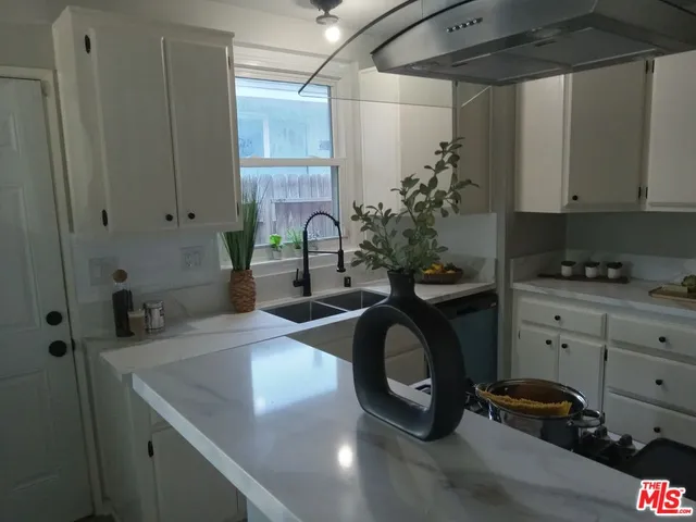 a kitchen with a sink and cabinets