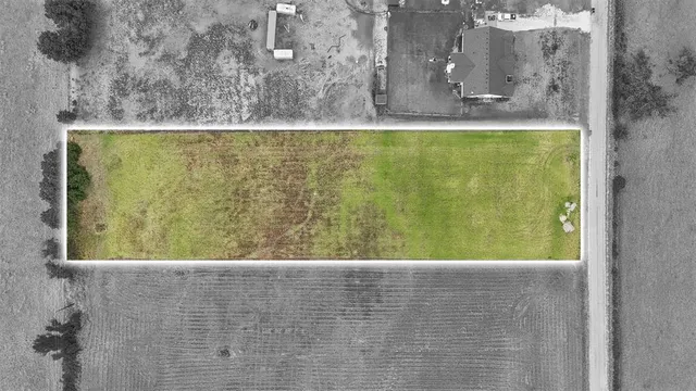 an aerial view of a house with a swimming pool