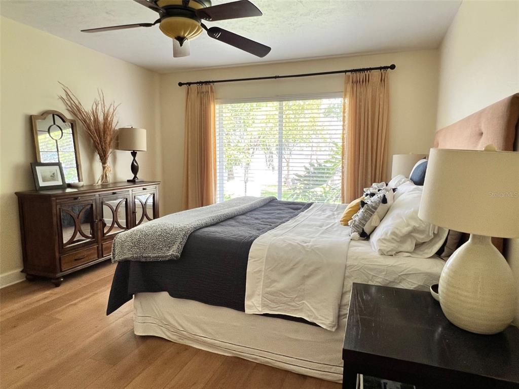 12595 Southeast Sunset Harbor Road Weirsdale, FL 32195 - Photo 11 of 25 a bedroom with a bed and wooden floor