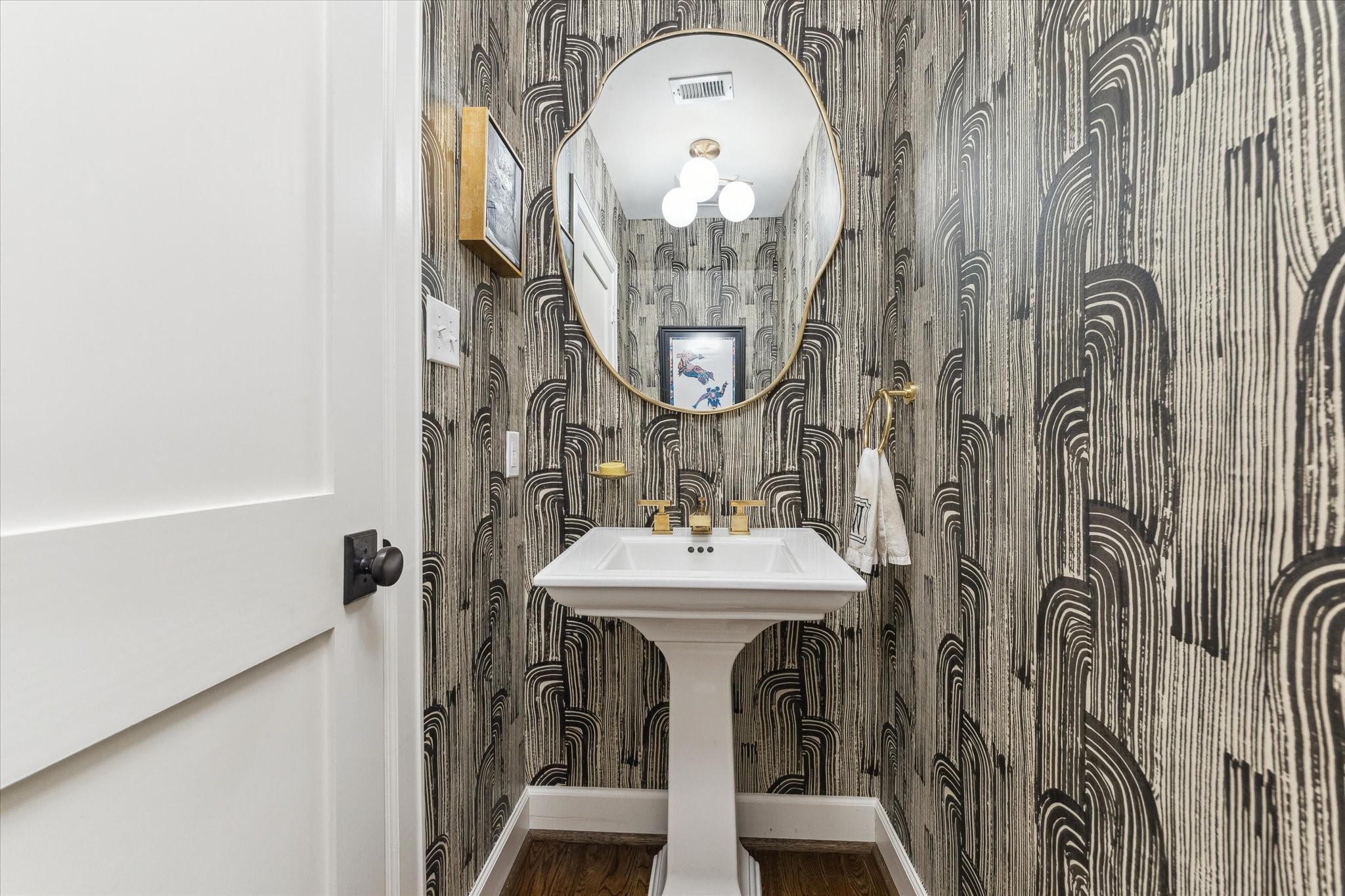 2124 Sul Ross Street Houston, TX 77098 - Photo 12 of 36 First floor powder room with Kelly Wearstler wallpaper.