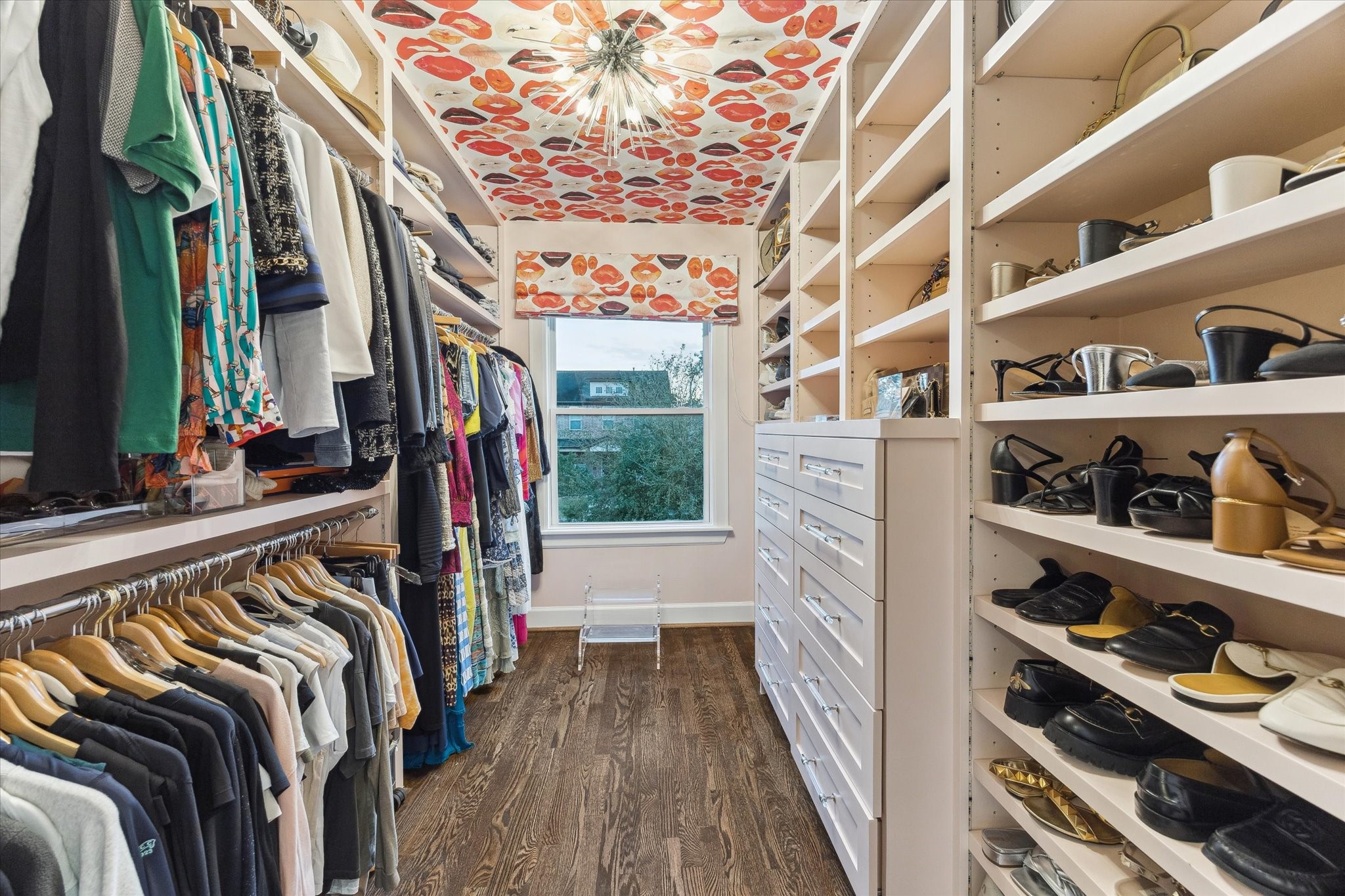 2124 Sul Ross Street Houston, TX 77098 - Photo 21 of 36 One of two closets in the primary. This one is custom with Voutsa wallpaper, strip lighting throughout shelving and drawers as well as double and single hanging space.
